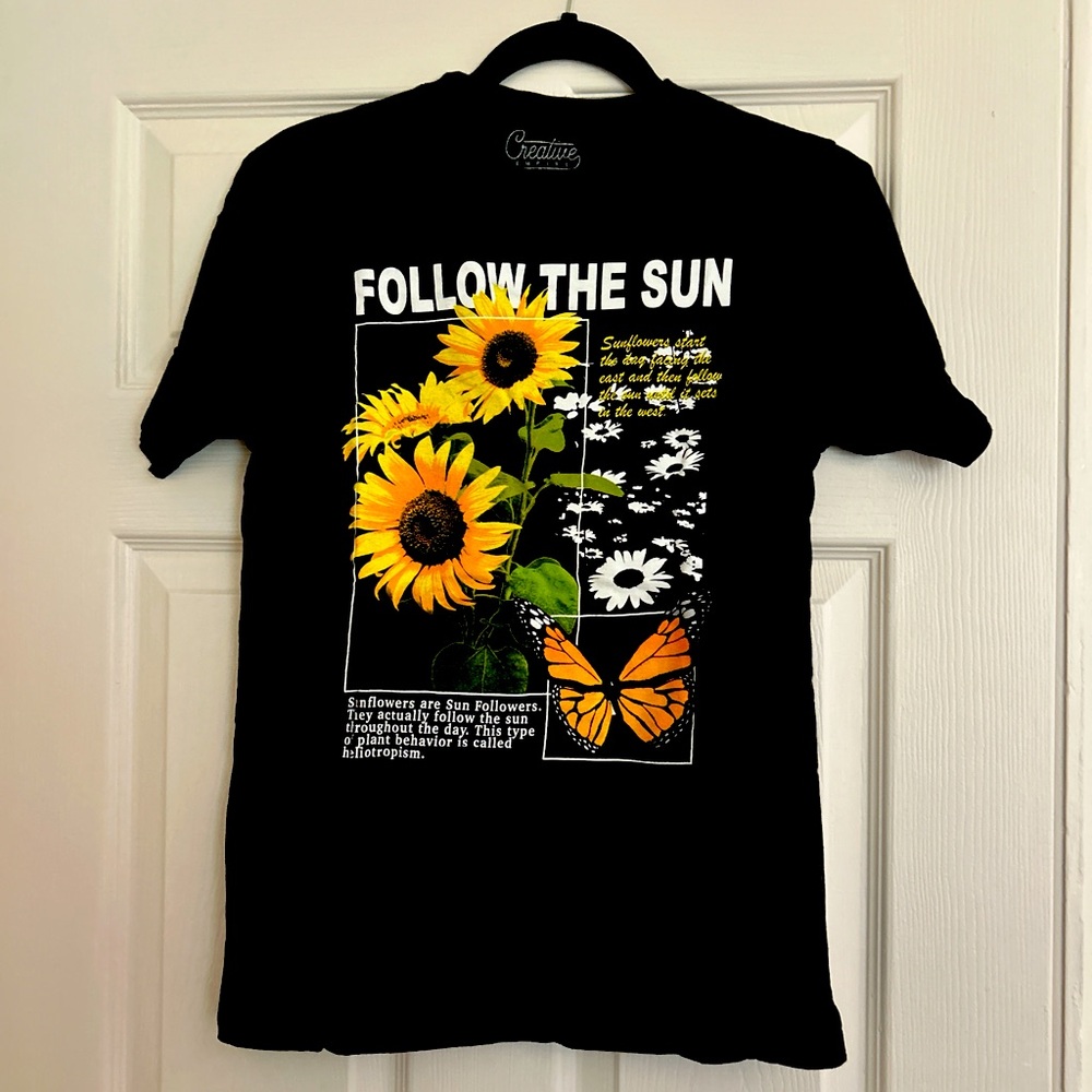 Black and yellow “Follow The Sun” graphic tee